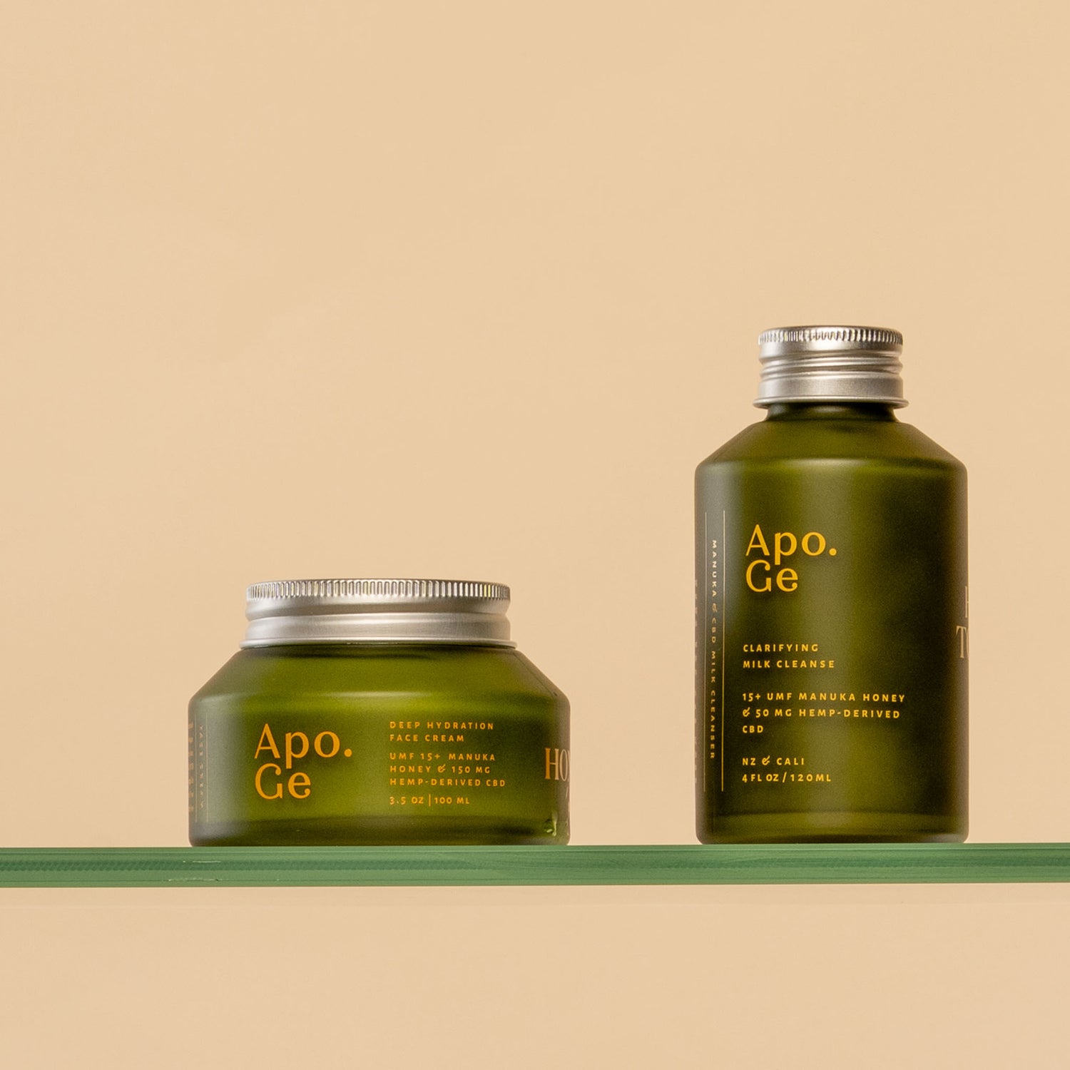 apo ge manuka honey skincare essentials set on a glass shelf with a beige background