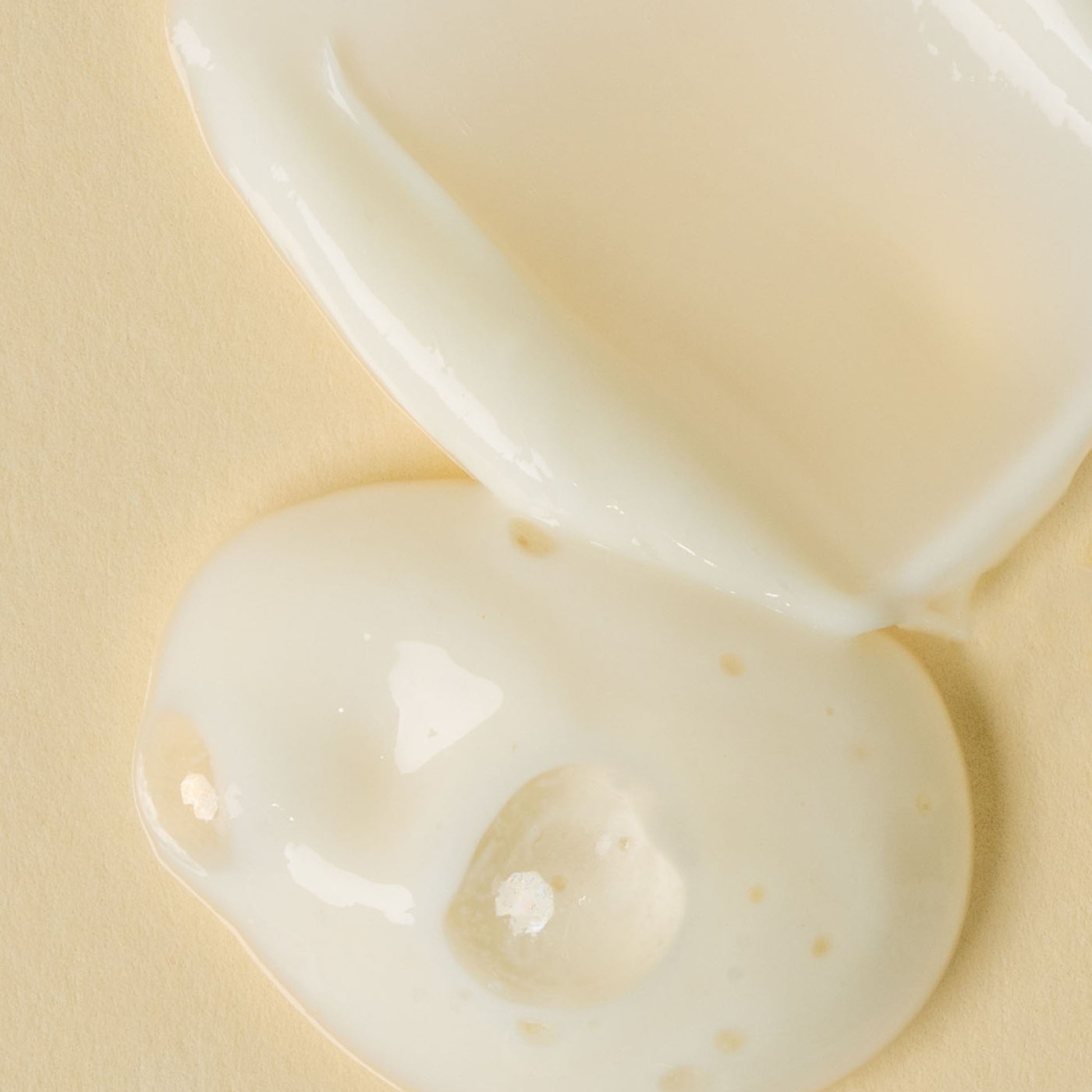 close up of apo ge manuka honey skincare deep hydration face cream and clarifying milk cleanse product texture