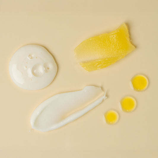 apo ge manuka honey skincare complete care set product texture swatches on a beige background