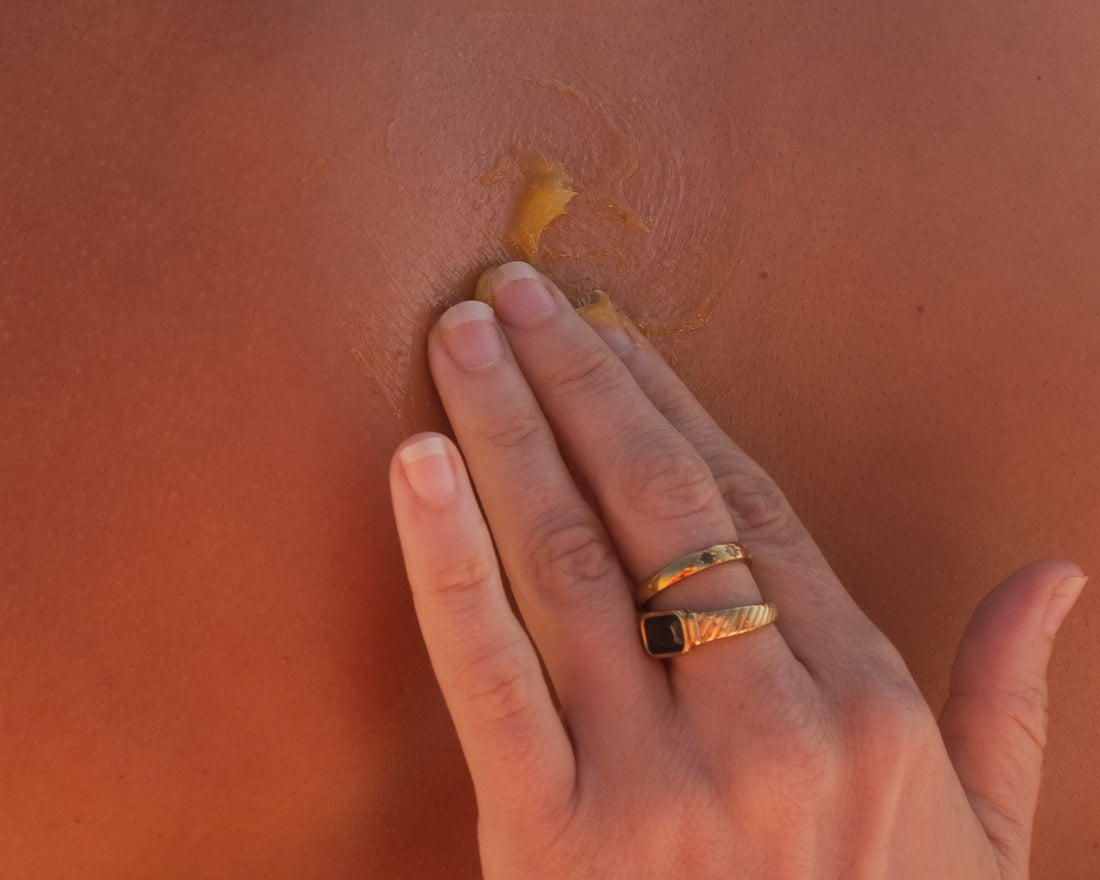 Hand applying balm to skin