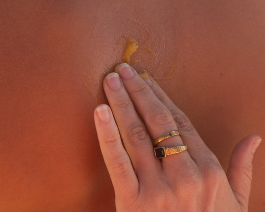 Hand applying balm to skin