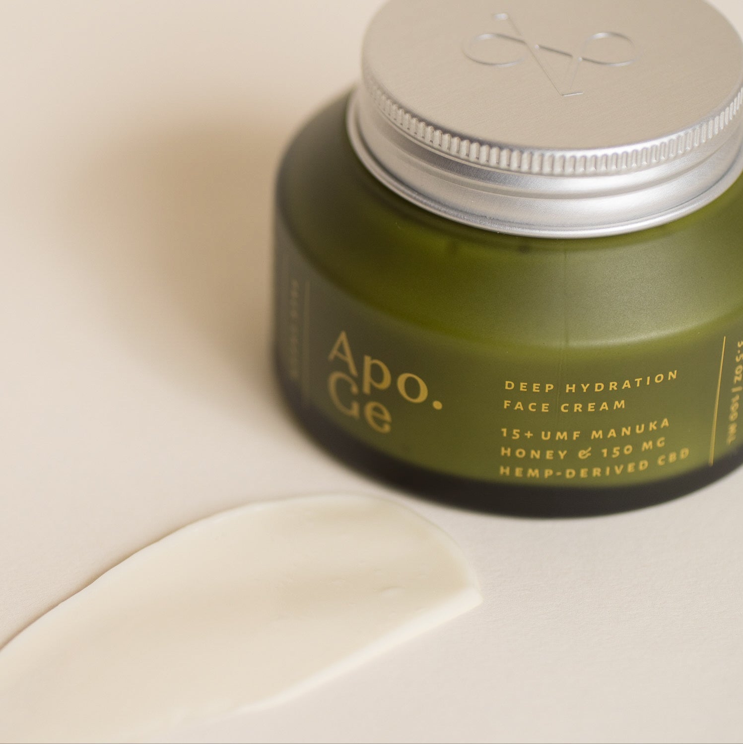 Green jar of Apo.Ge deep hydration face cream on a beige surface