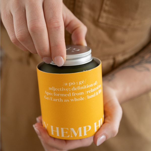 womans hands removing apo ge manuka honey skincare glass jar from packaging 