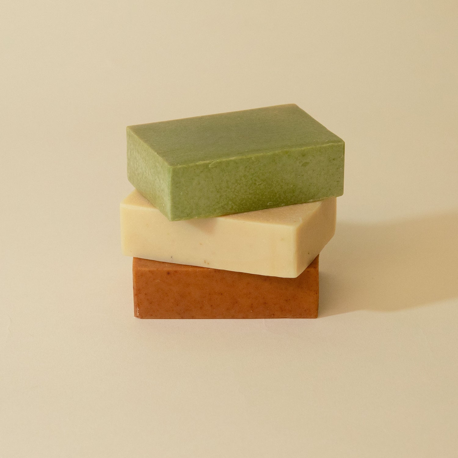 Three stacked soap bars, clear bar, sensitive skin bar, balance bar