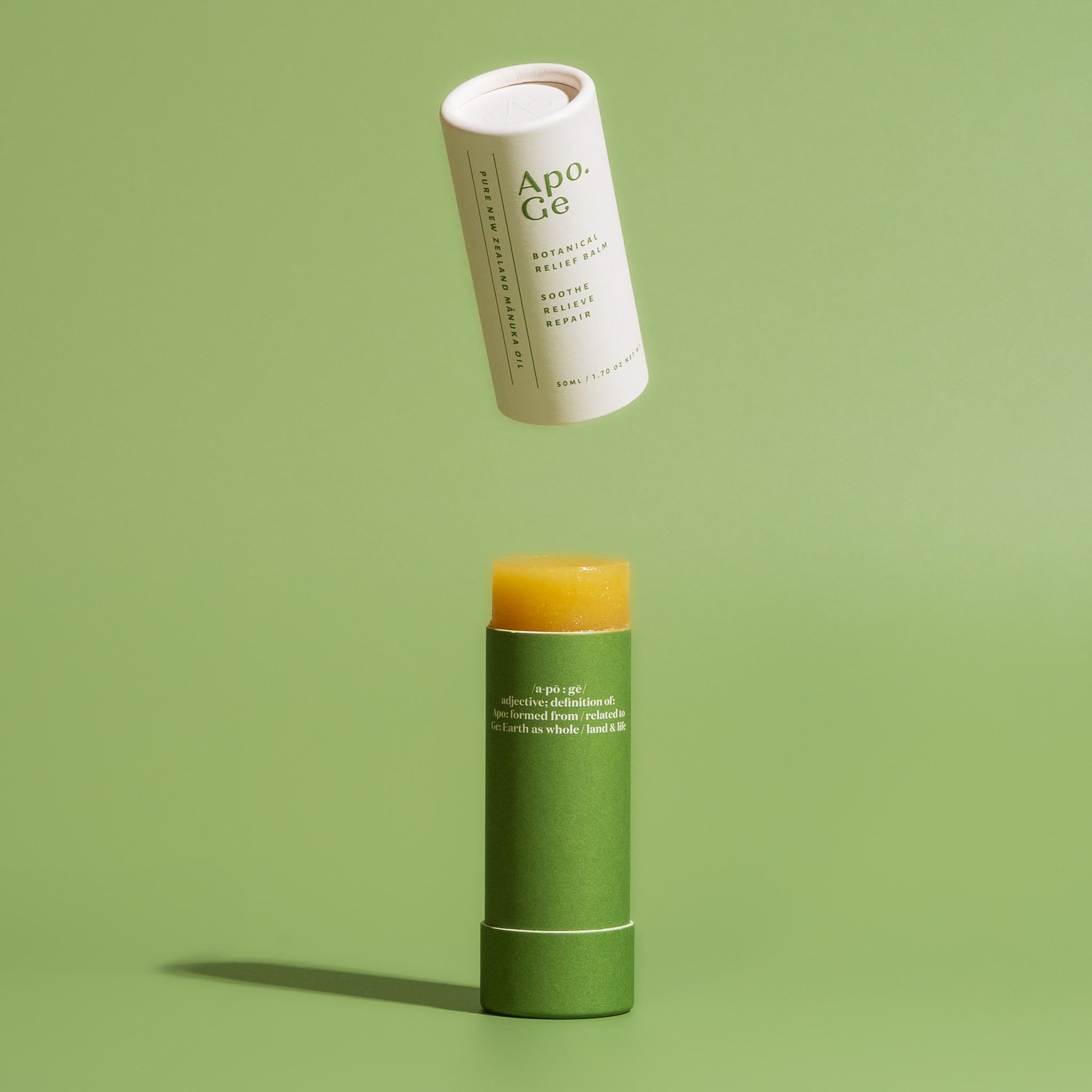 Apo.Ge Botanical Relief Balm on a green background.