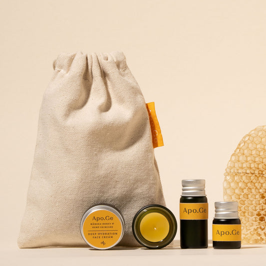 apo ge manuka honey skincare discovery set with canvas sample set bag on a white background with honeycomb