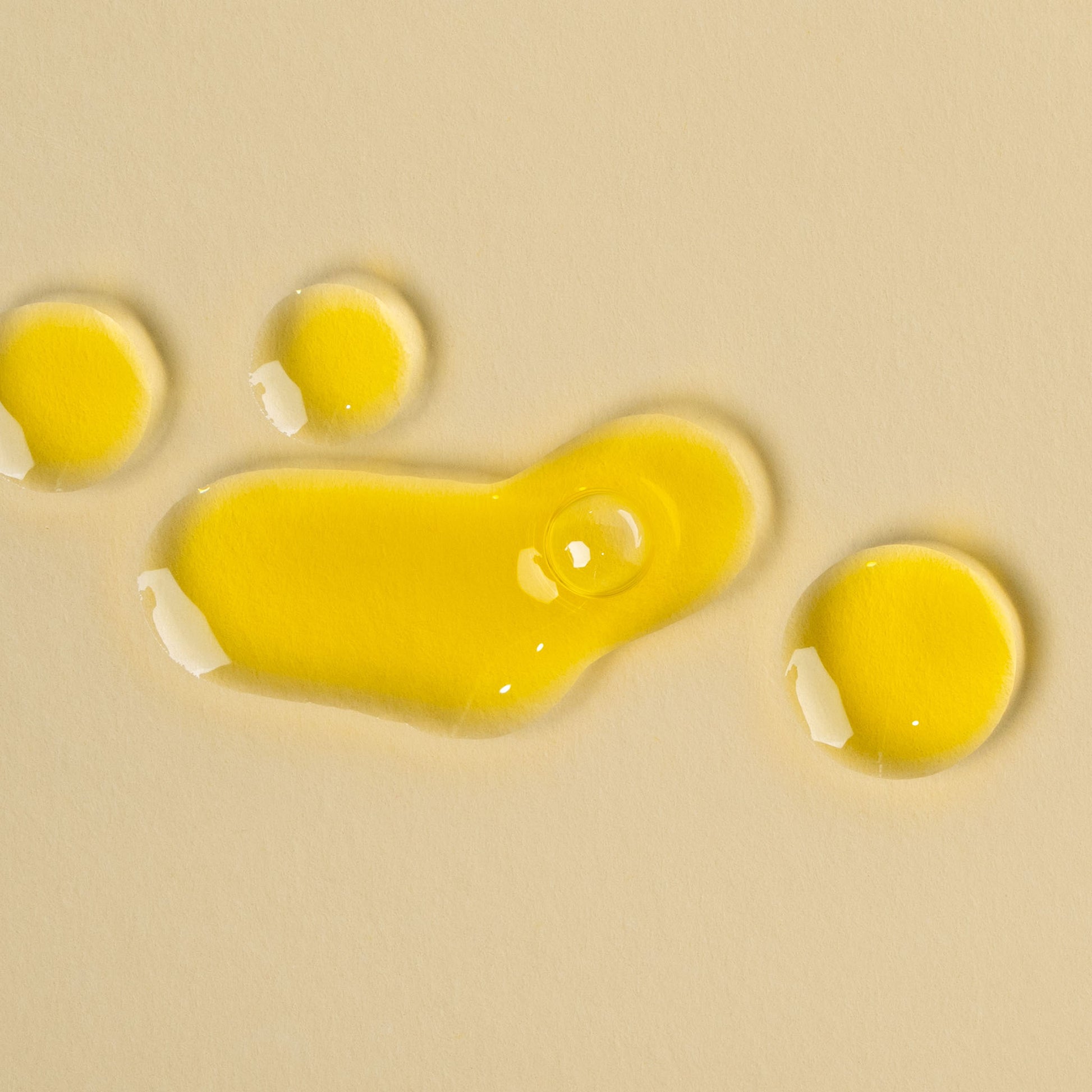 apo ge manuka honey skincare renwing night elixer droplets on a beige background