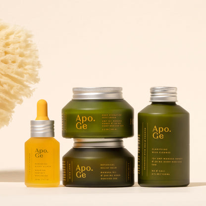 apo ge manuka honey skincare comlete care set featuring the renewing night elixerbotanical relief balm clarifying milk cleanse deepydration face cream on a deigh background