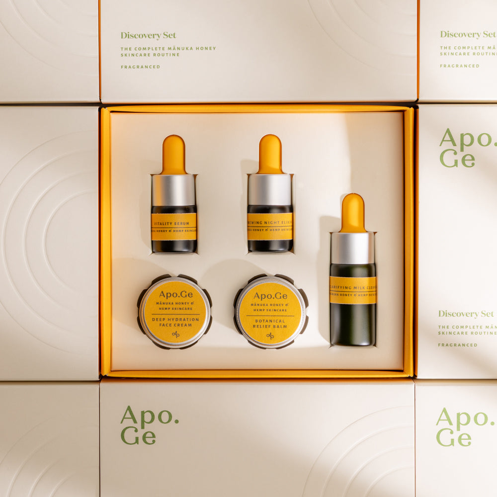 Apo.Ge skincare product set with bottles and jars in a box on a beige background